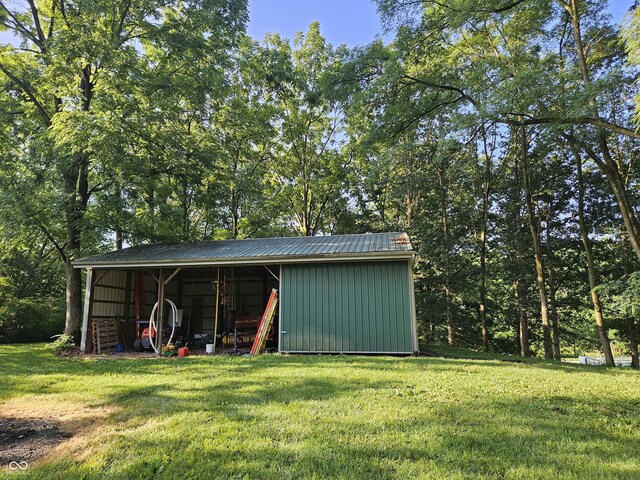 view of pole building with a yard