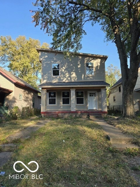 view of front of house featuring a front yard and covered porch