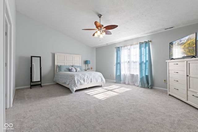 unfurnished bedroom featuring ceiling fan, light carpet, a textured ceiling, and high vaulted ceiling