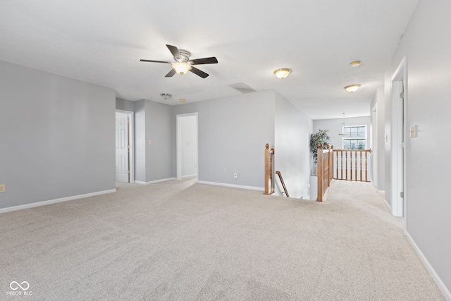 unfurnished room with ceiling fan and light colored carpet