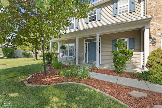 view of front facade with covered porch and a front yard