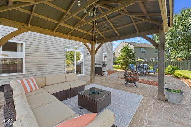 view of patio featuring a gazebo, an outdoor living space with a fire pit, and grilling area