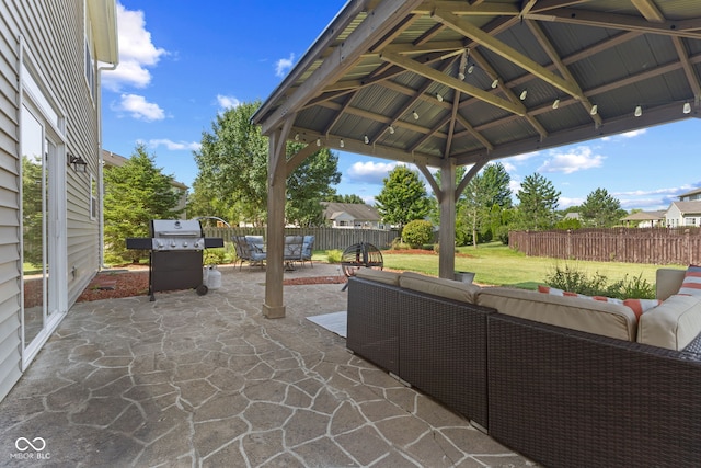 view of patio / terrace with an outdoor living space, a grill, and a gazebo