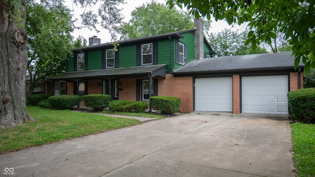 view of front property featuring a garage and a front lawn