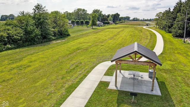 view of property's community featuring a gazebo, a yard, and a patio