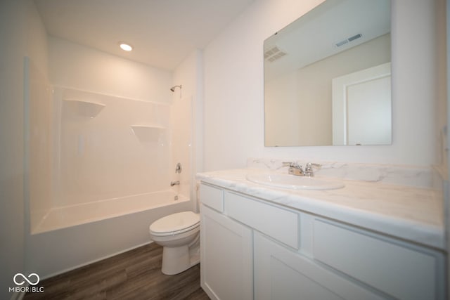 full bathroom featuring shower / bath combination, vanity, hardwood / wood-style flooring, and toilet