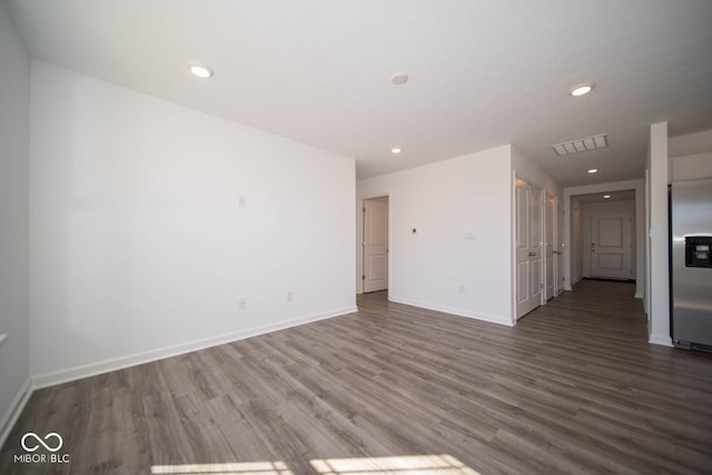 empty room featuring dark hardwood / wood-style flooring