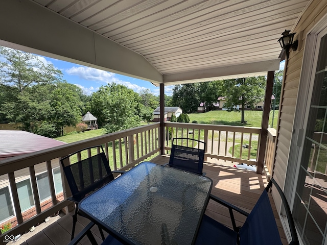 wooden deck with a lawn