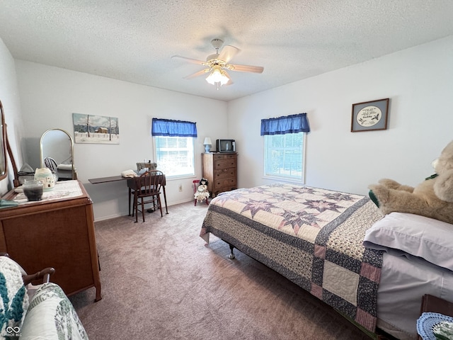 bedroom featuring ceiling fan, carpet, and a textured ceiling