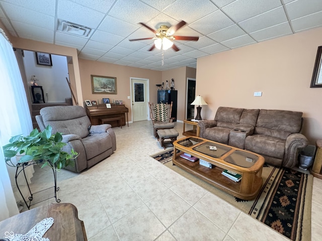 tiled living room featuring a paneled ceiling and ceiling fan