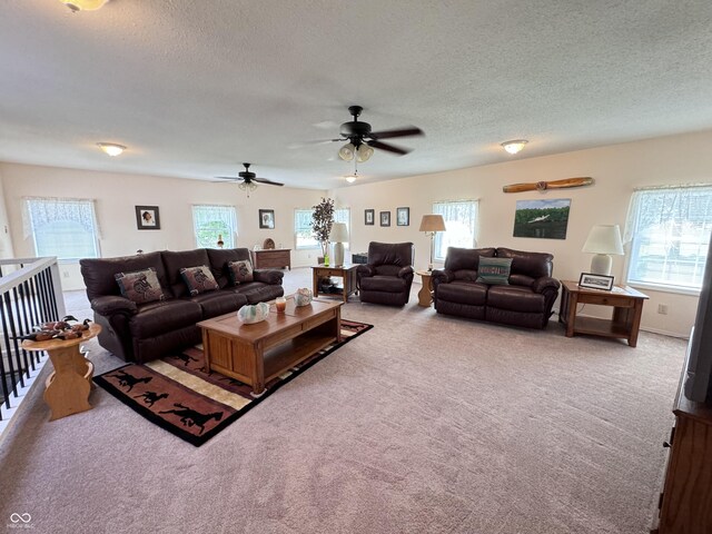 carpeted living room with plenty of natural light and a textured ceiling