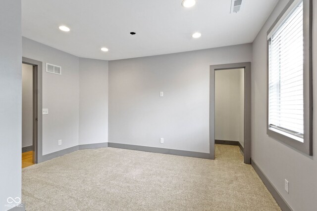 4513 Norwaldo Ave, Indianapolis, IN 46205 - spare room featuring light carpet and a wealth of natural light