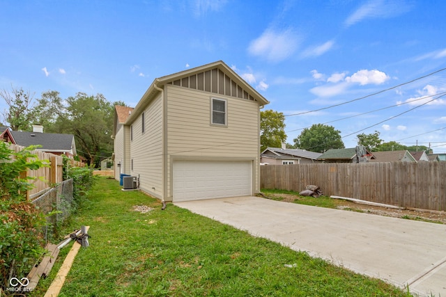 4513 Norwaldo Ave, Indianapolis, IN 46205 - view of home's exterior featuring a garage, a yard, and cooling unit
