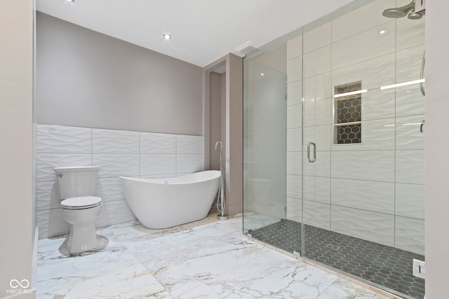 4513 Norwaldo Ave, Indianapolis, IN 46205 - bathroom with shower with separate bathtub, tile walls, and toilet
