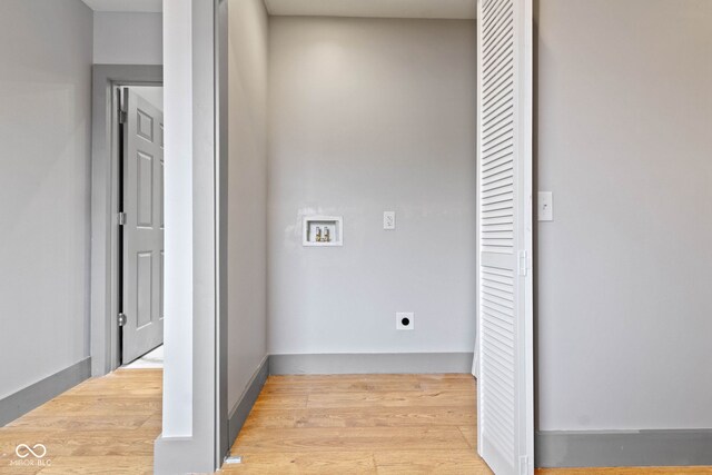 laundry room with electric dryer hookup, light hardwood / wood-style flooring, and washer hookup