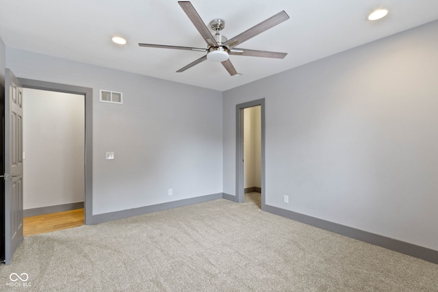 unfurnished room featuring ceiling fan and light colored carpet