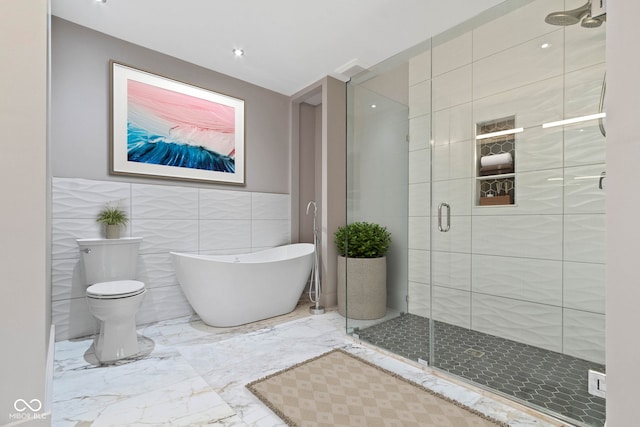 bathroom featuring a shower with door, toilet, tile patterned flooring, and tile walls