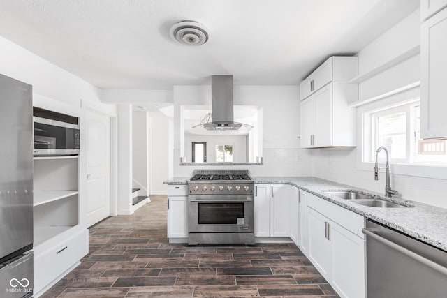 kitchen with ventilation hood, white cabinets, sink, appliances with stainless steel finishes, and backsplash