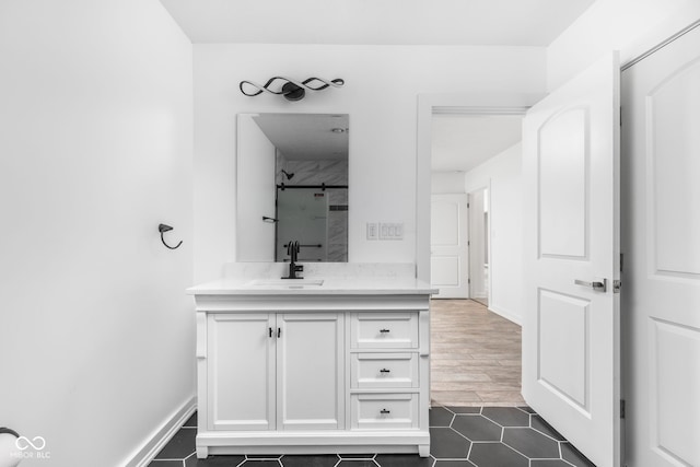 bathroom featuring wood-type flooring, vanity, and a tile shower