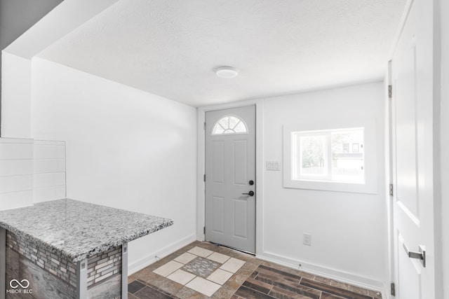 foyer entrance featuring a textured ceiling