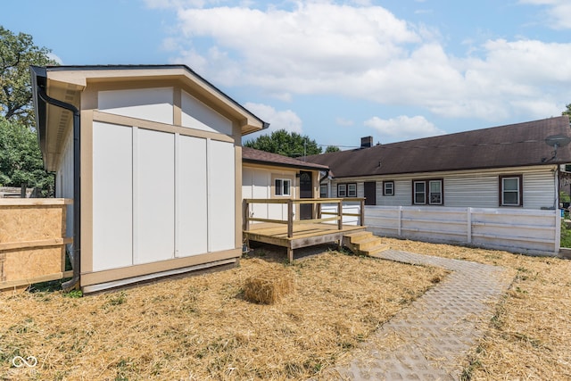 rear view of property with a wooden deck