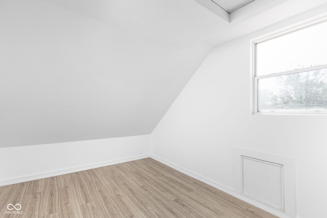 bonus room featuring light hardwood / wood-style flooring and vaulted ceiling