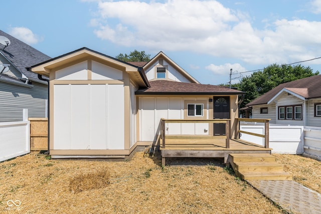 view of front facade featuring a shed and a wooden deck