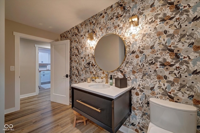 bathroom with vanity, toilet, and wood-type flooring