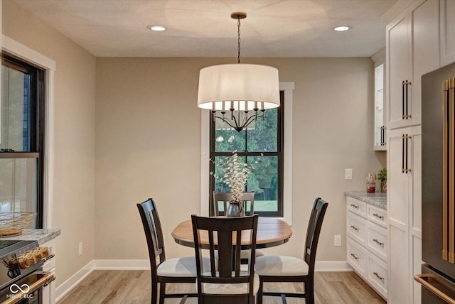 dining space with light hardwood / wood-style flooring