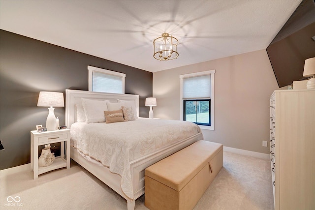 carpeted bedroom with an inviting chandelier