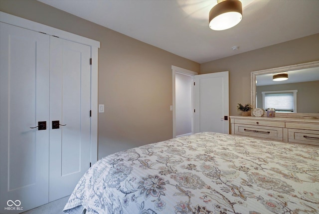 bedroom featuring a closet and light colored carpet