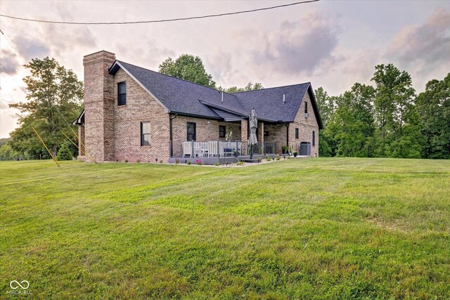 view of front facade with central air condition unit and a front lawn