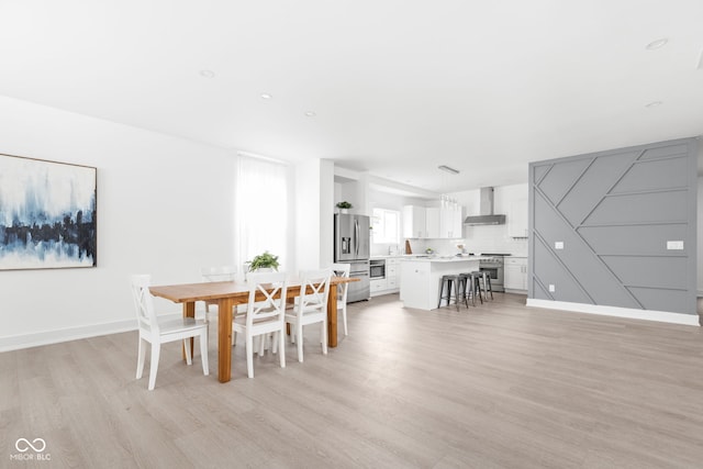 dining space featuring light wood-type flooring