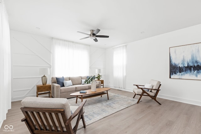 living room featuring ceiling fan and light wood-type flooring