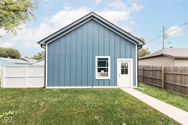 view of outbuilding featuring a lawn