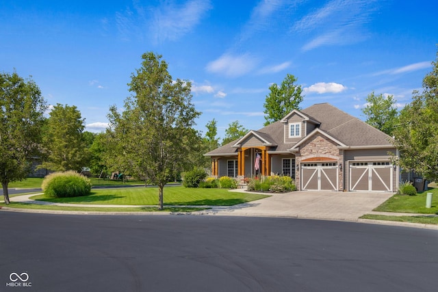 craftsman house featuring a garage and a front yard