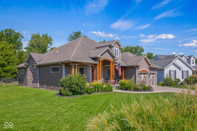 view of front of home with a garage and a front lawn