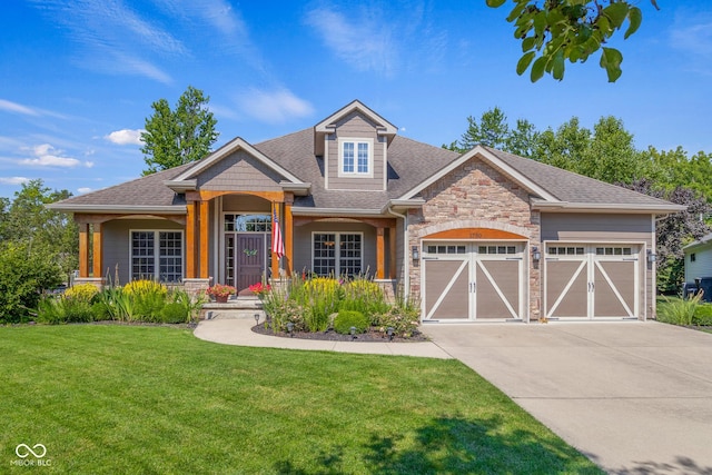 view of front facade with a porch, a garage, and a front lawn