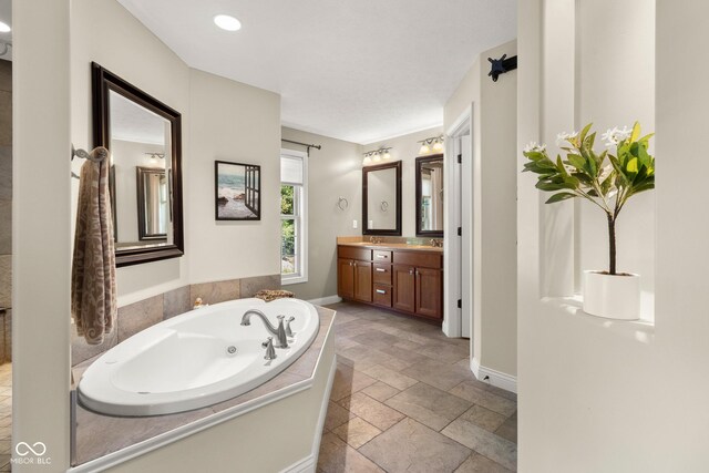 bathroom featuring vanity and a bath