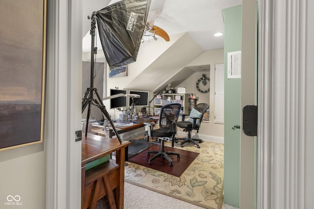 home office featuring vaulted ceiling, carpet, and ceiling fan