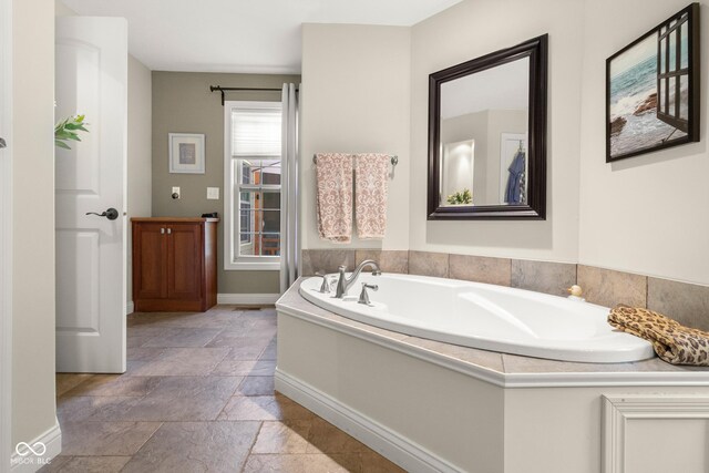 bathroom with a tub to relax in