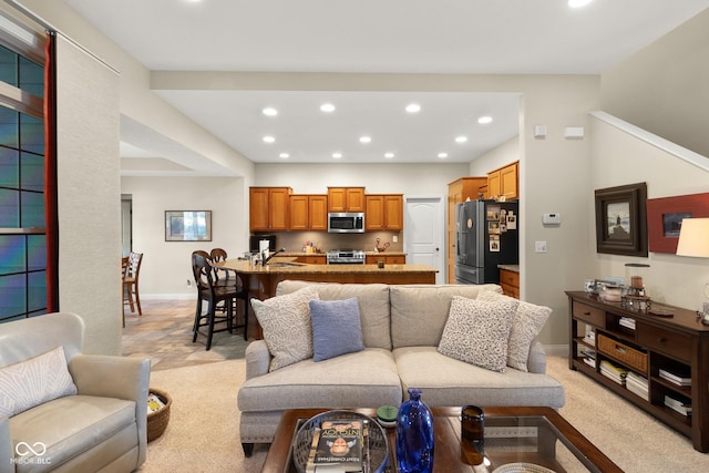 carpeted living room with sink