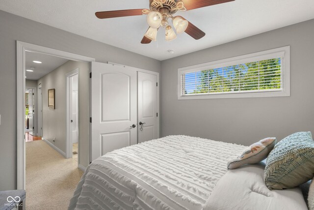 carpeted bedroom with a closet and ceiling fan