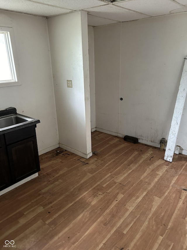 laundry room featuring sink and wood-type flooring