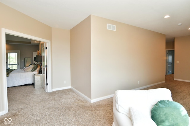 living area featuring recessed lighting, carpet flooring, visible vents, and baseboards