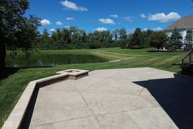 view of home's community featuring a patio area, a water view, and a lawn