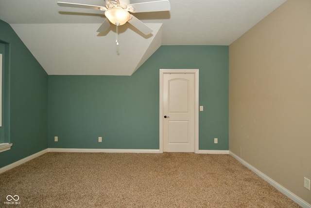 bonus room featuring lofted ceiling, carpet floors, a ceiling fan, and baseboards