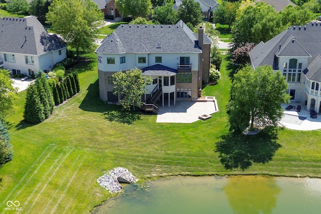 birds eye view of property with a water view