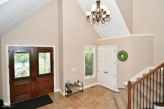 entryway with stairs, high vaulted ceiling, french doors, and plenty of natural light