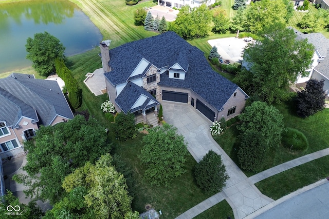 birds eye view of property with a water view